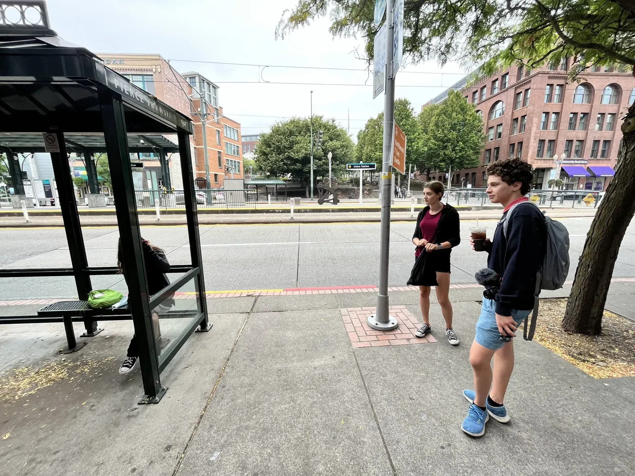 Alice, Jonah, and Anneke waiting for the 1 bus to arrive